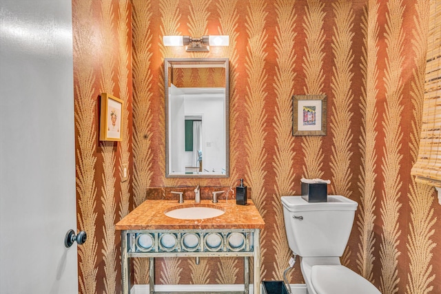 3421 Exeter St SW, Roanoke, VA 24014 - half bathroom featuring toilet, vanity, and wallpapered walls