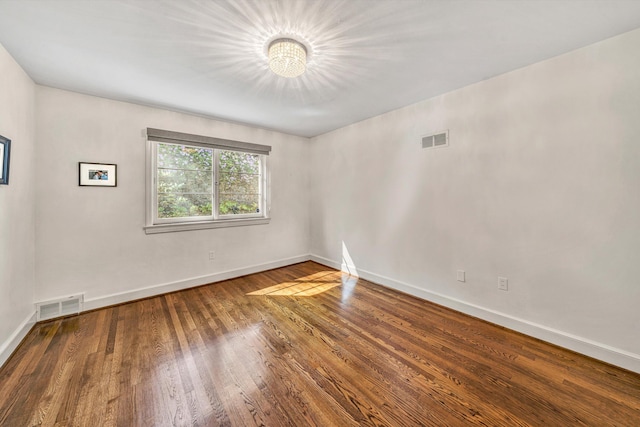 3421 Exeter St SW, Roanoke, VA 24014 - spare room with baseboards, wood finished floors, visible vents, and an inviting chandelier