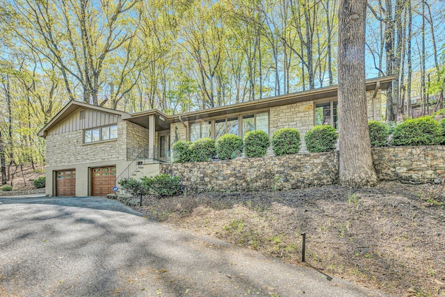 3421 Exeter St SW, Roanoke, VA 24014 - view of front of property featuring driveway, stone siding, stairway, and a garage