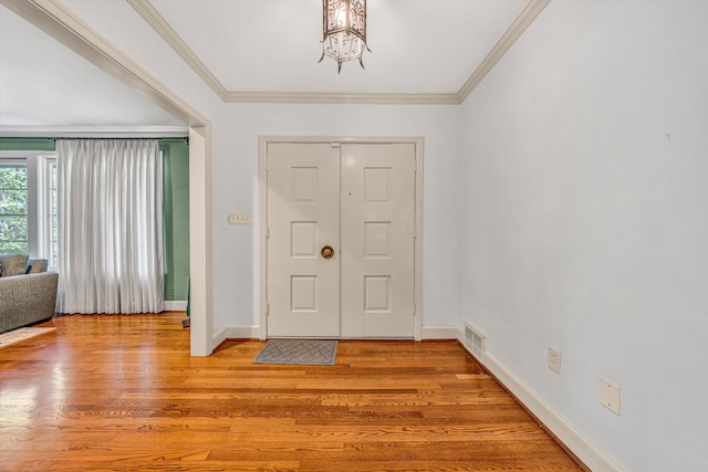 3421 Exeter St SW, Roanoke, VA 24014 - entryway featuring ornamental molding, a notable chandelier, visible vents, and light wood-type flooring