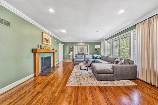 3421 Exeter St SW, Roanoke, VA 24014 - living room with wood finished floors, baseboards, a fireplace with raised hearth, and ornamental molding