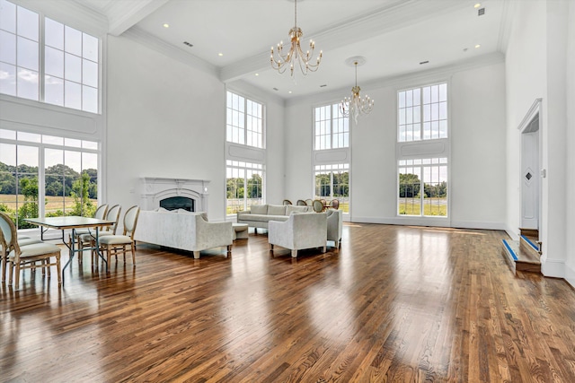 189 Old Buckingham Rd, Cumberland, VA 23040 - living room with a chandelier, a towering ceiling, crown molding, a fireplace, and wood finished floors