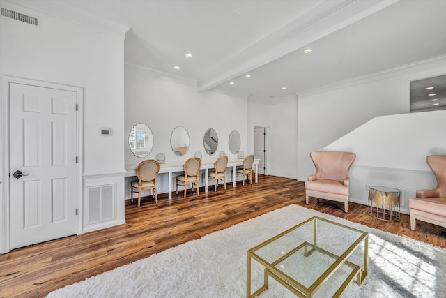 sitting room with recessed lighting, wood finished floors, visible vents, and ornamental molding