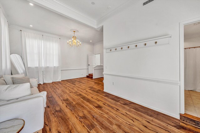 living room with wood finished floors, an inviting chandelier, ornamental molding, visible vents, and recessed lighting