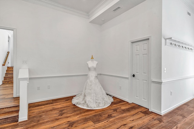 recreation room with visible vents, baseboards, wood finished floors, and crown molding