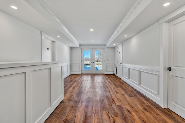 interior space featuring a decorative wall, french doors, a wainscoted wall, dark wood finished floors, and recessed lighting