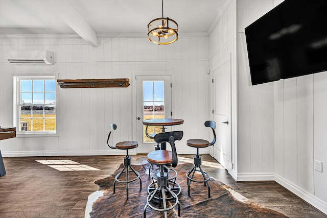 dining area with dark wood finished floors, baseboards, beam ceiling, and a wall unit AC