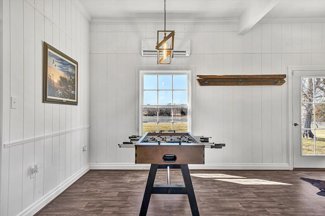 playroom with beam ceiling, baseboards, wood finished floors, wooden walls, and a wall mounted AC