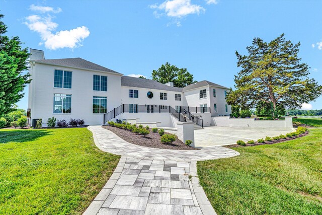 189 Old Buckingham Rd, Cumberland, VA 23040 - rear view of house featuring a yard, a patio, and stucco siding