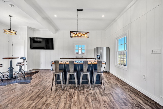 dining space with a chandelier, ornamental molding, baseboards, and dark wood-style flooring