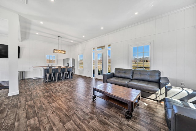 living area with recessed lighting, crown molding, and dark wood-style flooring