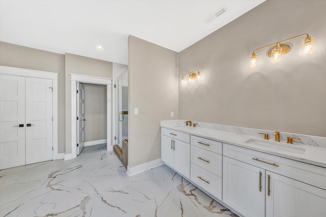 full bathroom with a sink, a stall shower, marble finish floor, baseboards, and visible vents