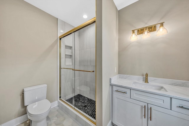 full bath featuring a stall shower, baseboards, vanity, and toilet
