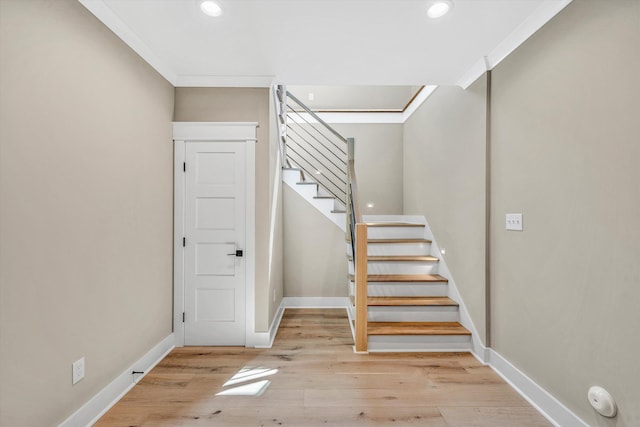 stairs featuring wood finished floors, baseboards, recessed lighting, and ornamental molding