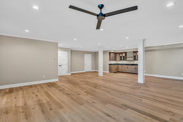 unfurnished living room featuring decorative columns, light wood-style flooring, baseboards, visible vents, and recessed lighting