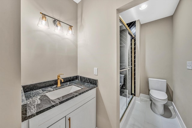 bathroom with tile patterned floors, toilet, a stall shower, baseboards, and vanity