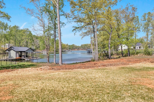 view of yard featuring a dock and a water view