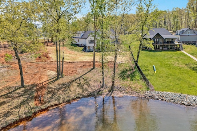 surrounding community featuring a water view and a yard