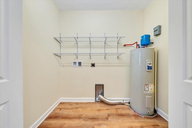 clothes washing area featuring water heater, hookup for an electric dryer, wood finished floors, and laundry area