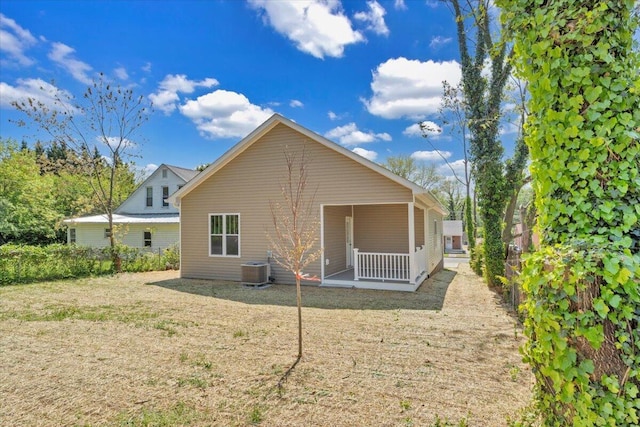 rear view of property with central AC