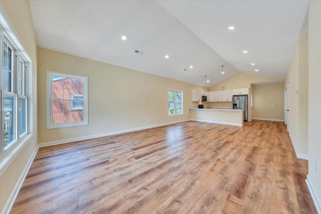 unfurnished living room featuring lofted ceiling, baseboards, light wood-style flooring, and visible vents