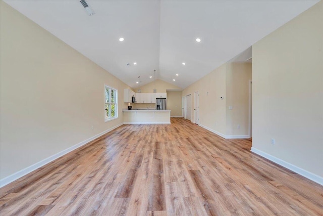 unfurnished living room featuring recessed lighting, lofted ceiling, visible vents, baseboards, and light wood-style flooring