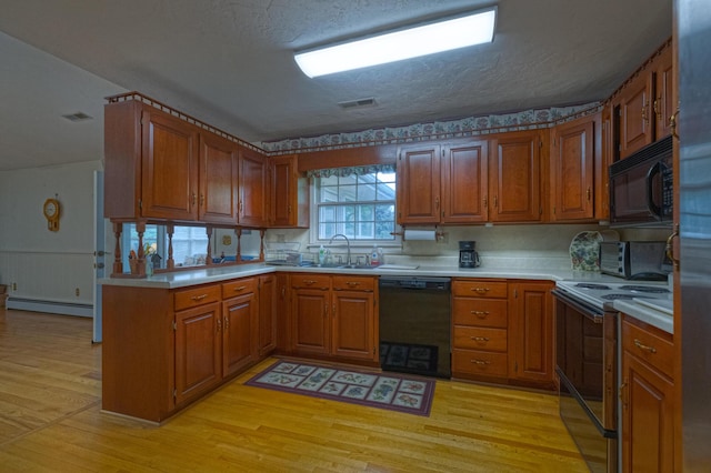 1615 Deyerle Rd SW, Roanoke, VA 24015 - kitchen featuring black appliances, a baseboard heating unit, brown cabinetry, wainscoting, and a textured ceiling