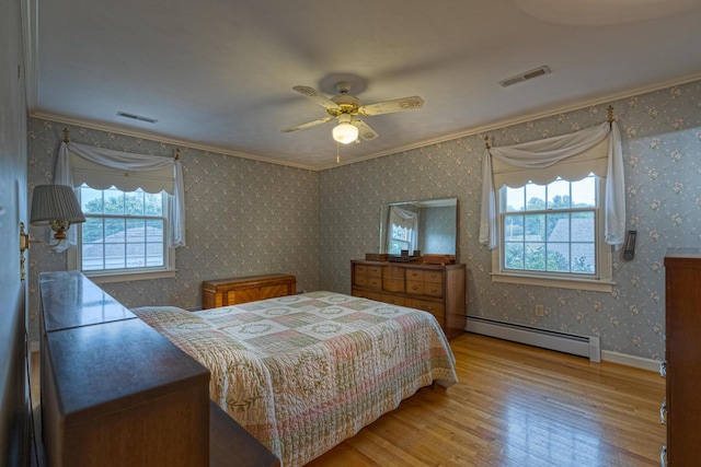 1615 Deyerle Rd SW, Roanoke, VA 24015 - bedroom with a baseboard radiator, wood finished floors, crown molding, a ceiling fan, and baseboards