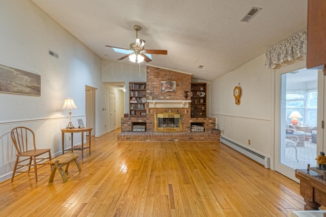 1615 Deyerle Rd SW, Roanoke, VA 24015 - living room with baseboard heating, ceiling fan, lofted ceiling, a brick fireplace, and light wood-style floors
