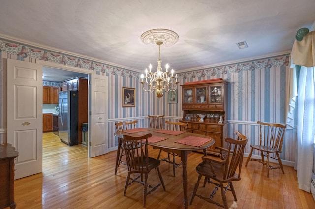 1615 Deyerle Rd SW, Roanoke, VA 24015 - dining space featuring wallpapered walls, a chandelier, light wood-type flooring, and crown molding