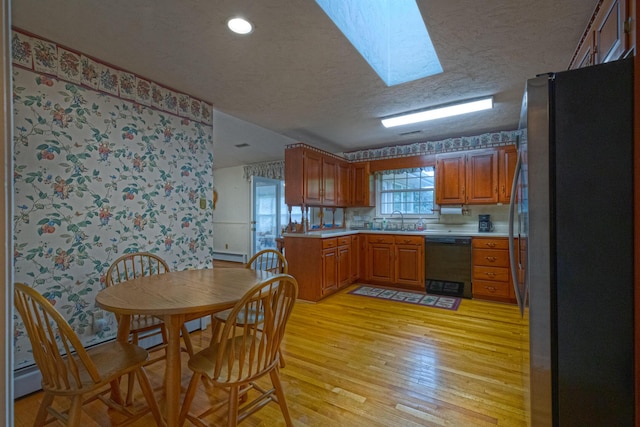 1615 Deyerle Rd SW, Roanoke, VA 24015 - kitchen featuring dishwasher, freestanding refrigerator, a sink, a textured ceiling, and light countertops
