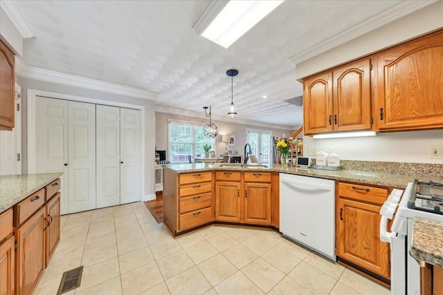 kitchen featuring crown molding, a sink, white appliances, brown cabinetry, and a peninsula