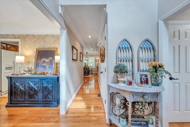 corridor featuring baseboards, ornamental molding, recessed lighting, and wood finished floors