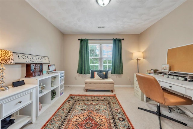 home office featuring a textured ceiling, baseboards, visible vents, and light carpet