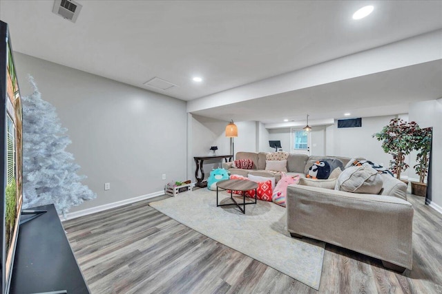 living area with baseboards, recessed lighting, wood finished floors, and visible vents