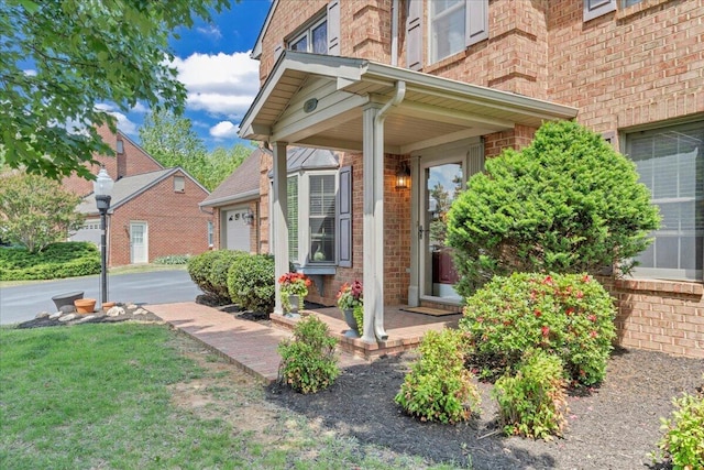 entrance to property featuring brick siding