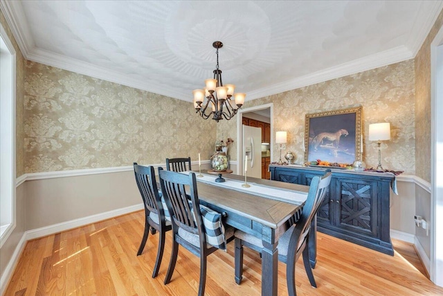 dining space featuring wallpapered walls, a notable chandelier, baseboards, and light wood-type flooring