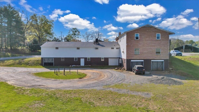 14189 Franklin St, Ferrum, VA 24088 - rear view of property featuring an attached garage, driveway, and a lawn
