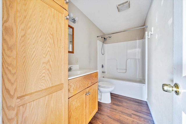 14189 Franklin St, Ferrum, VA 24088 - full bath with wood finished floors, visible vents, toilet, vanity, and shower / bathtub combination