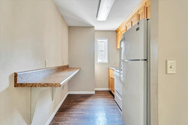 14189 Franklin St, Ferrum, VA 24088 - kitchen featuring baseboards, white appliances, light countertops, dark wood-type flooring, and a breakfast bar area