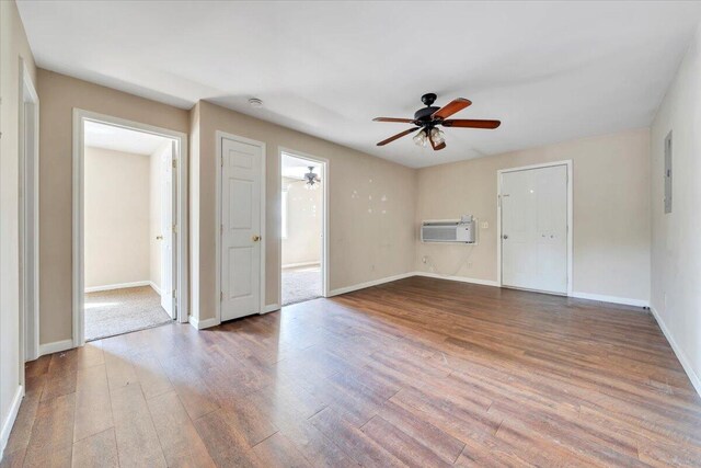 14189 Franklin St, Ferrum, VA 24088 - unfurnished room with baseboards, wood finished floors, a wall unit AC, and ceiling fan