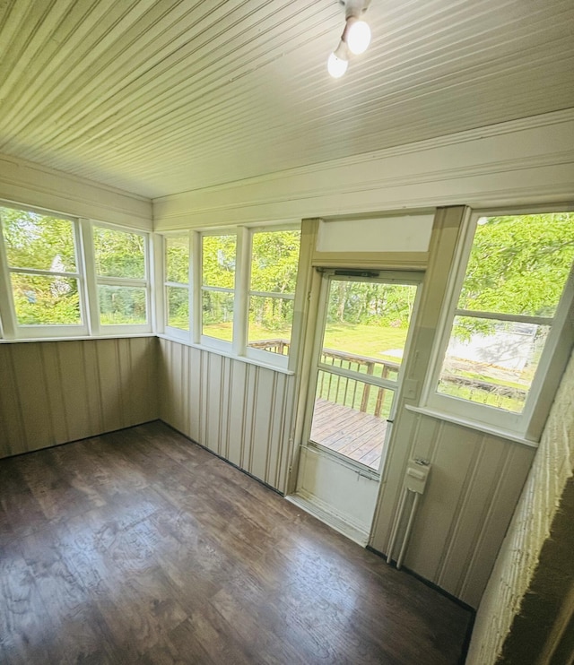 unfurnished sunroom featuring plenty of natural light and wood finished floors