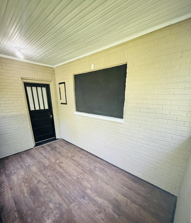 view of exterior entry featuring brick siding