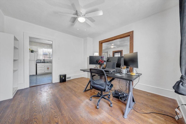 office with ceiling fan, wood finished floors, and baseboards