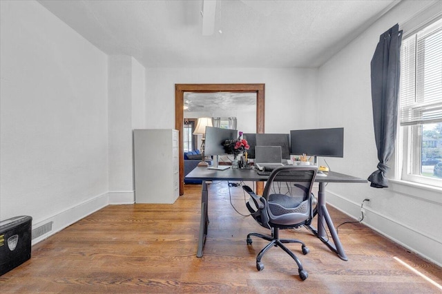 office space with wood finished floors and baseboards