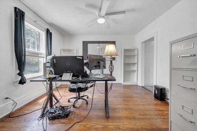 home office with wood finished floors, ceiling fan, and baseboards