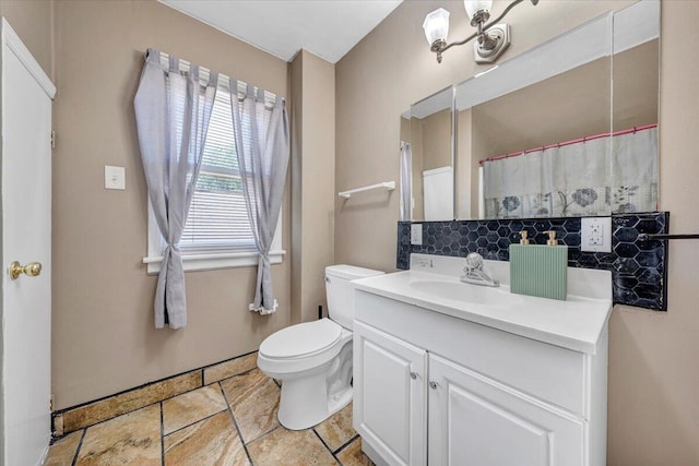 full bath featuring toilet, vanity, decorative backsplash, and tile patterned flooring