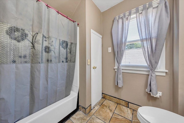 full bathroom with shower / bath combo and toilet