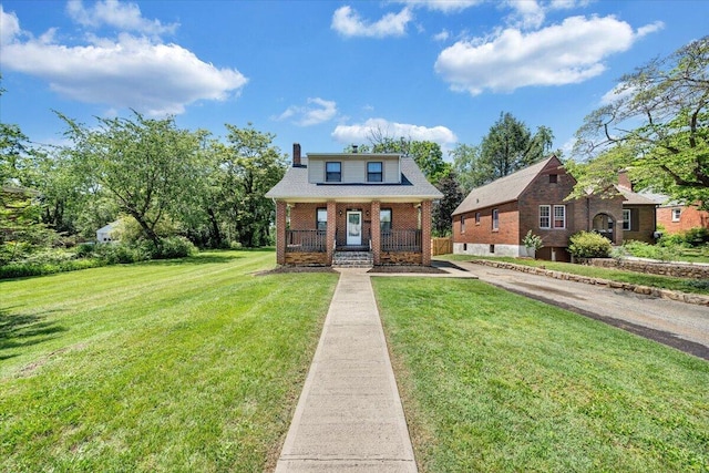 bungalow-style house featuring covered porch, a front yard, and brick siding