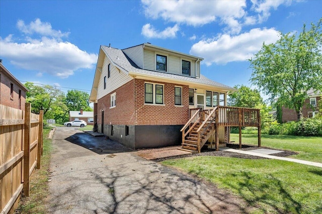 view of front of property featuring stairs, brick siding, and a wooden deck